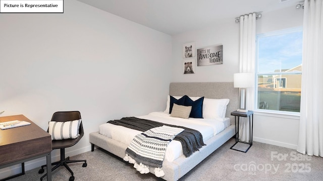 carpeted bedroom featuring baseboards