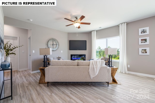 living room featuring ceiling fan and light hardwood / wood-style floors