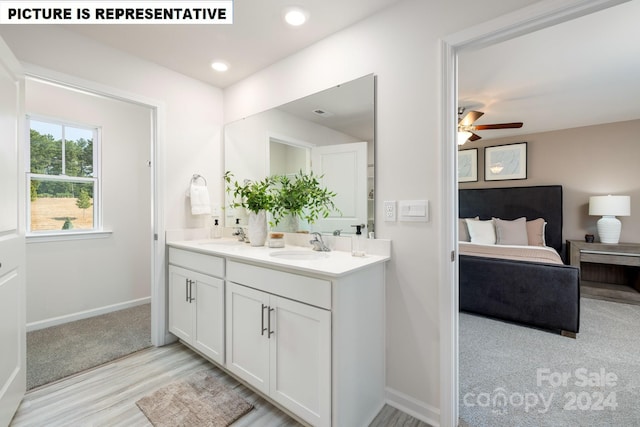 bathroom featuring wood-type flooring, vanity, and ceiling fan