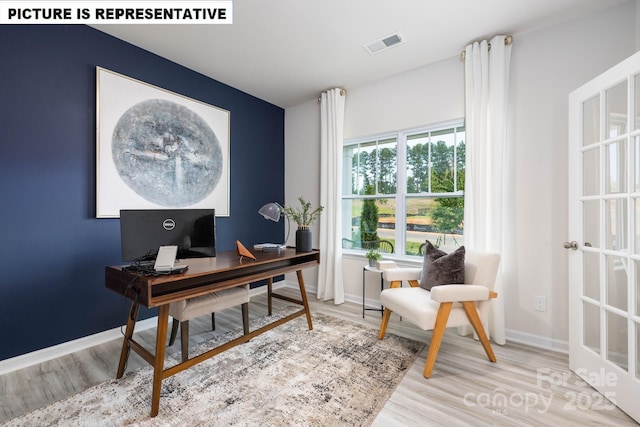 home office featuring baseboards, visible vents, and wood finished floors