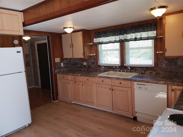 kitchen with light hardwood / wood-style floors, backsplash, white appliances, and sink