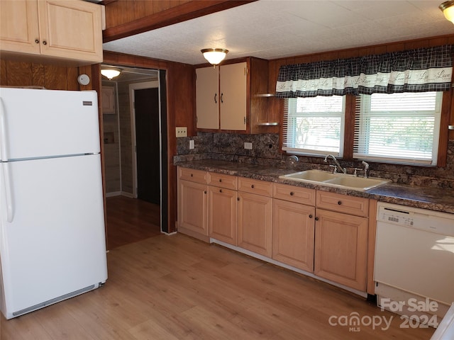 kitchen with light hardwood / wood-style floors, sink, white appliances, and decorative backsplash