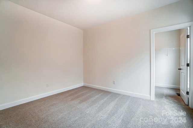 unfurnished bedroom featuring a closet and carpet