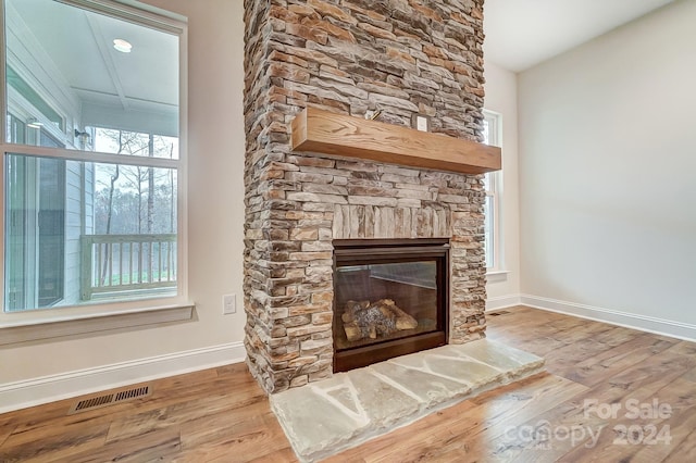 interior space featuring a stone fireplace and hardwood / wood-style flooring