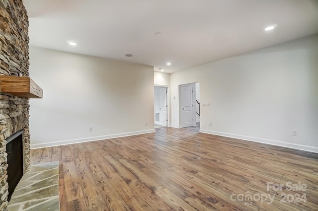 unfurnished living room featuring light hardwood / wood-style flooring and a fireplace