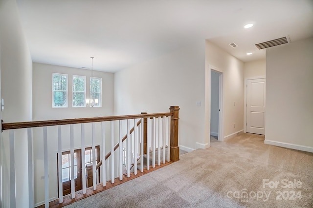 corridor with light colored carpet