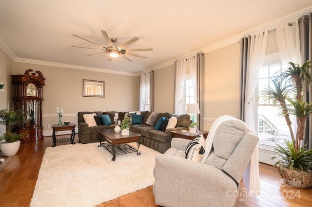 living room with wood-type flooring, crown molding, and ceiling fan