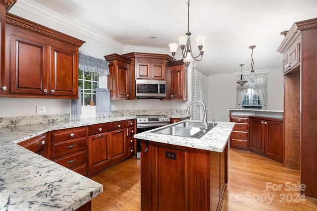 kitchen featuring a center island with sink, stainless steel appliances, plenty of natural light, and sink