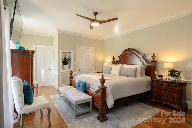 bedroom with ceiling fan, hardwood / wood-style flooring, and crown molding