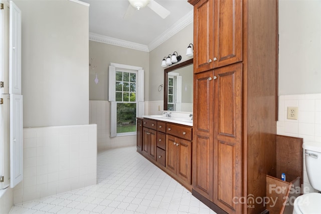 bathroom with tile patterned floors, crown molding, vanity, and toilet