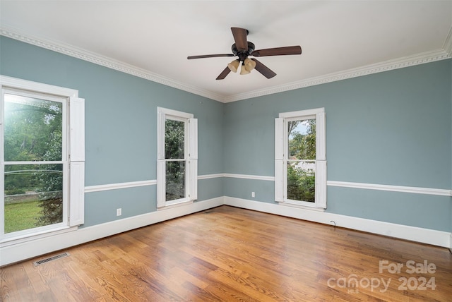 spare room with ornamental molding, hardwood / wood-style floors, and ceiling fan