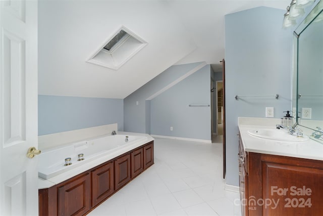 bathroom with lofted ceiling, vanity, a washtub, and tile patterned floors