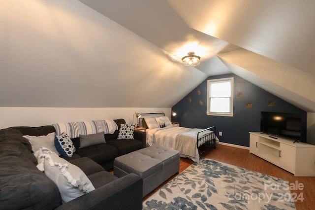 bedroom with lofted ceiling and hardwood / wood-style flooring