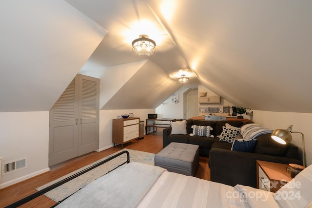 interior space with lofted ceiling, a closet, and hardwood / wood-style flooring