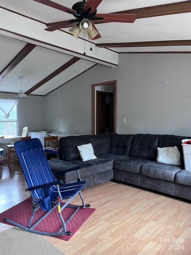 living room featuring lofted ceiling with beams, ceiling fan, and hardwood / wood-style flooring