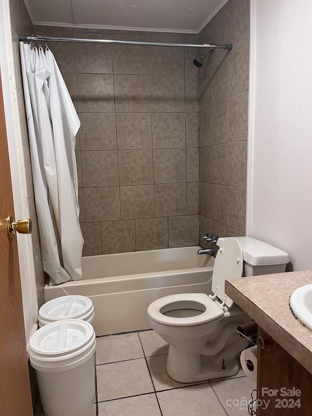 full bathroom featuring vanity, shower / tub combo with curtain, ornamental molding, toilet, and tile patterned floors