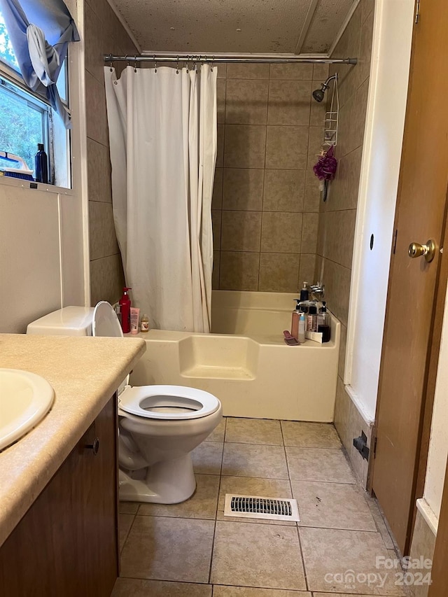 full bathroom featuring vanity, shower / tub combo, toilet, and tile patterned flooring