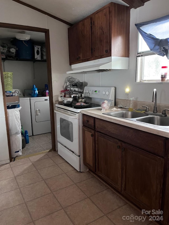 kitchen with sink, white electric range oven, dark brown cabinetry, light tile patterned floors, and washer and clothes dryer