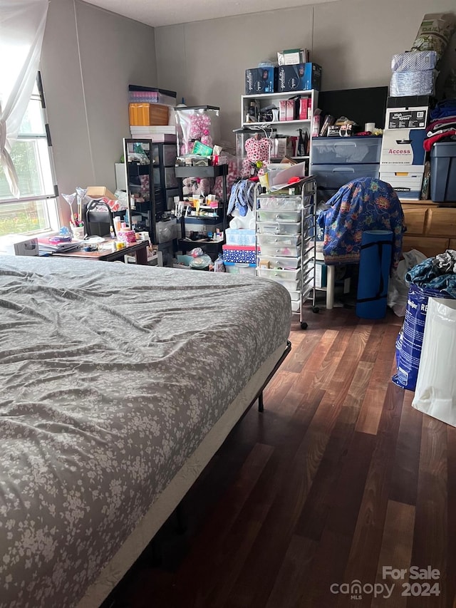 bedroom with dark wood-type flooring