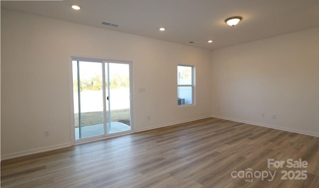 unfurnished room with wood-type flooring