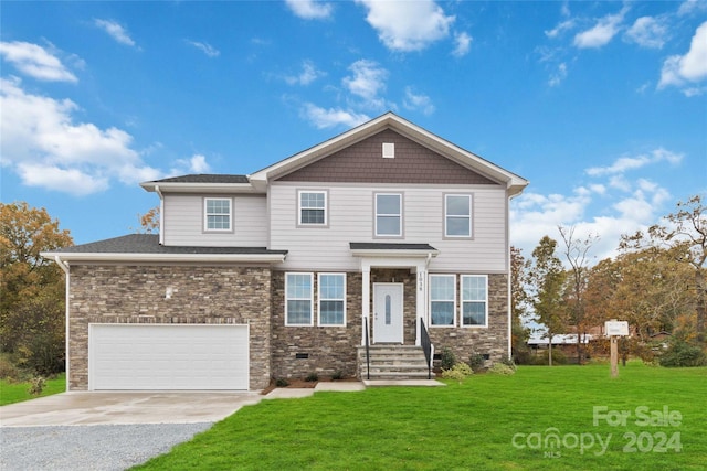 view of front of house featuring a garage and a front lawn