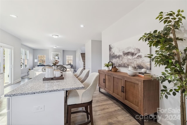1038 Heath Helms Rd, Monroe, NC 28110 - kitchen with open floor plan, light wood finished floors, a center island, a kitchen breakfast bar, and recessed lighting