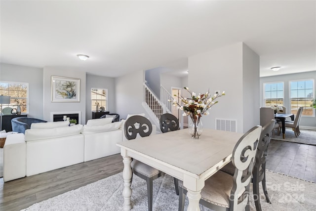 1038 Heath Helms Rd, Monroe, NC 28110 - dining area featuring wood finished floors, stairs, and a fireplace