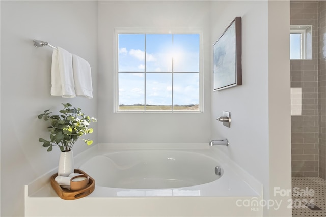1038 Heath Helms Rd, Monroe, NC 28110 - full bathroom with plenty of natural light, a bath, and a tile shower