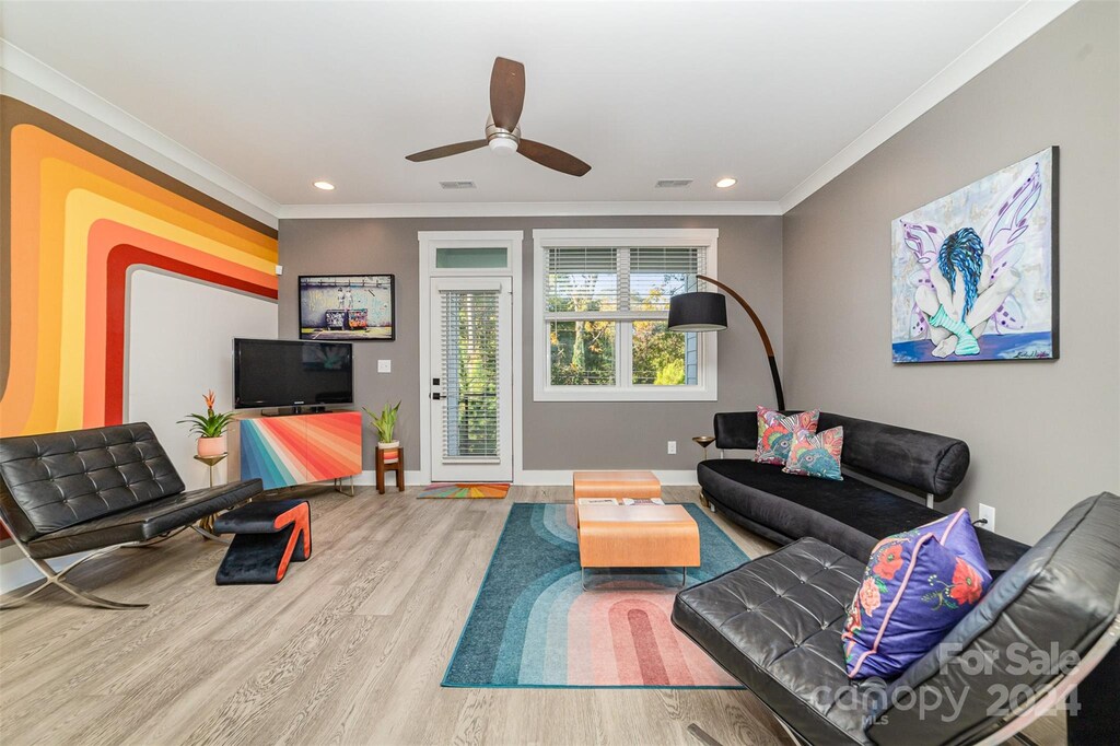 living room featuring ornamental molding, ceiling fan, and hardwood / wood-style flooring