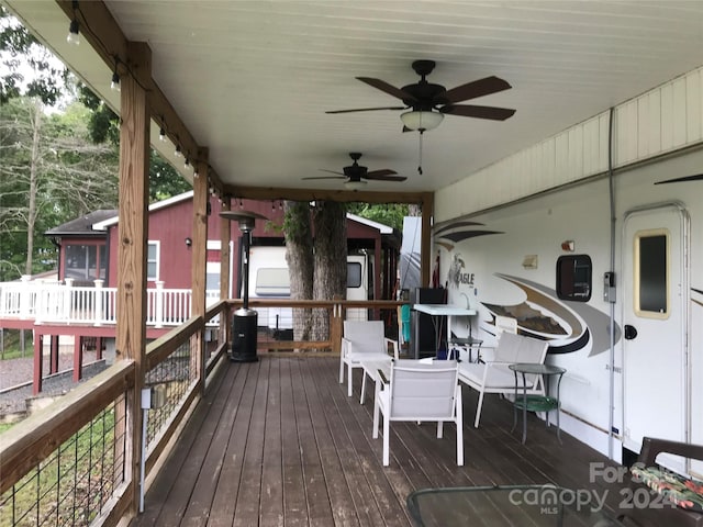 wooden terrace featuring ceiling fan