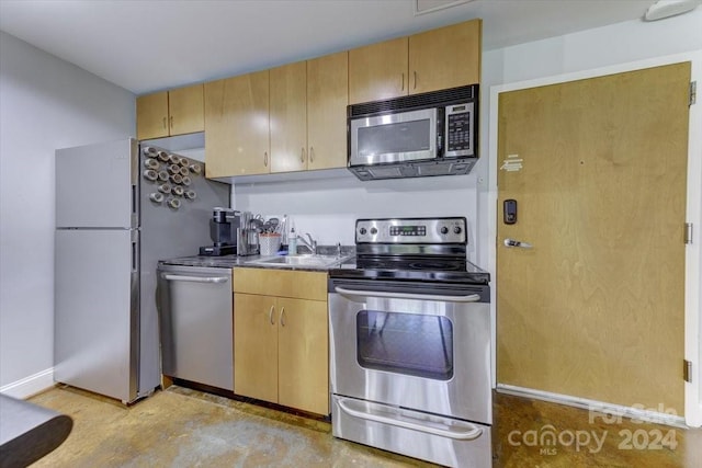 kitchen featuring light brown cabinets, appliances with stainless steel finishes, and sink