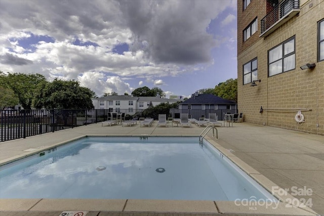 view of swimming pool with a patio area