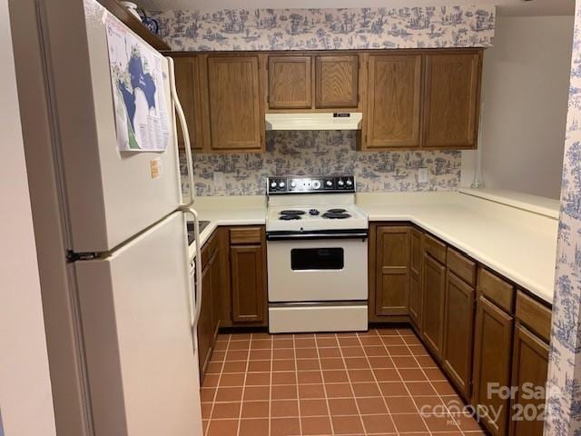 kitchen with light tile patterned flooring and white appliances