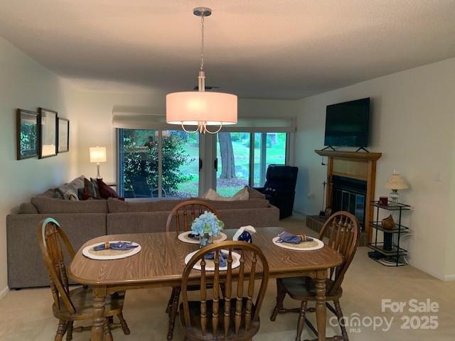 dining space featuring light colored carpet