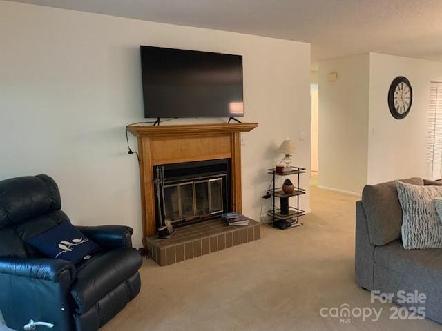 carpeted living room with a brick fireplace