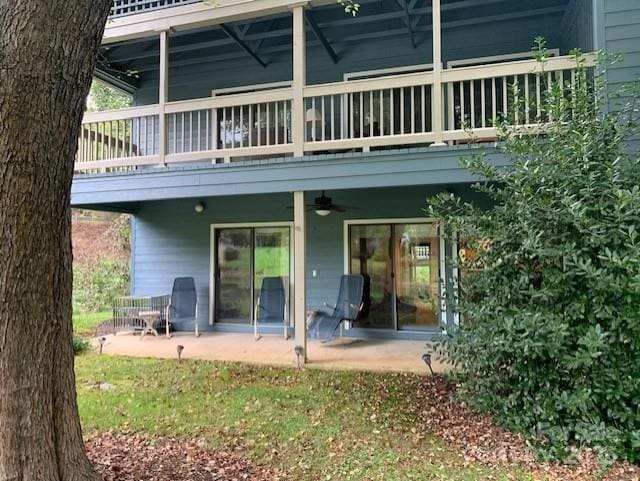 rear view of house with ceiling fan and a patio area