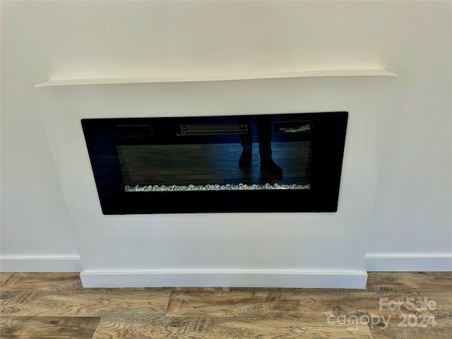 room details featuring baseboards and wood finished floors