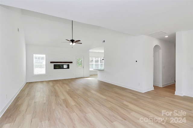 unfurnished living room featuring vaulted ceiling, light hardwood / wood-style flooring, and ceiling fan