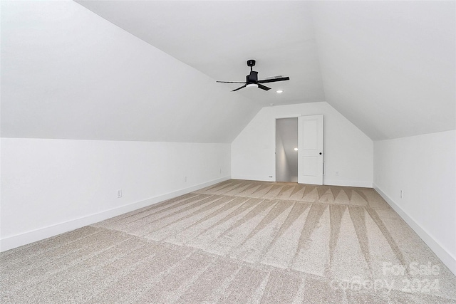 additional living space with ceiling fan, carpet floors, and lofted ceiling