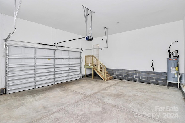 garage featuring a garage door opener and water heater