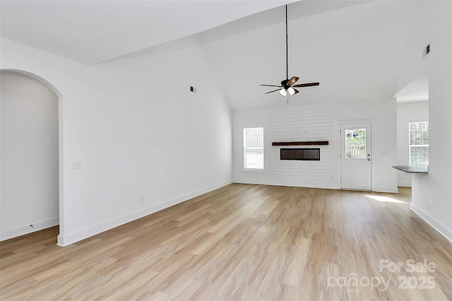 unfurnished living room featuring a fireplace, visible vents, a ceiling fan, baseboards, and light wood finished floors