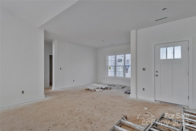 foyer entrance with baseboards and visible vents