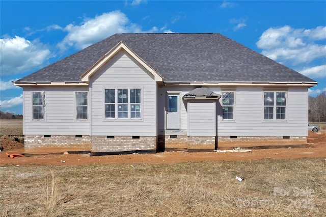 rear view of house with crawl space and roof with shingles