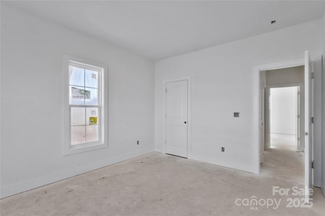 spare room featuring baseboards