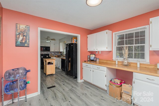 kitchen featuring white cabinets, ceiling fan, light hardwood / wood-style flooring, black appliances, and sink