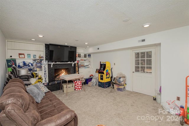 living room with light colored carpet, a textured ceiling, and a fireplace