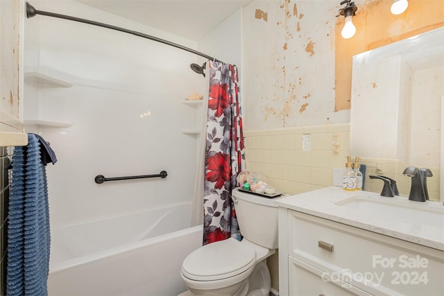 full bathroom featuring tile walls, vanity, shower / tub combo, and toilet