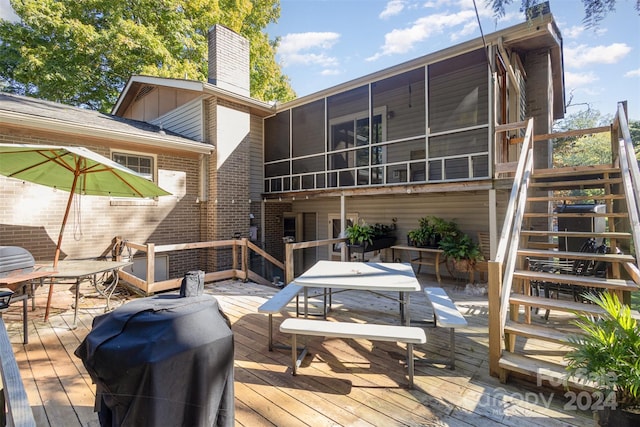 rear view of house with a wooden deck