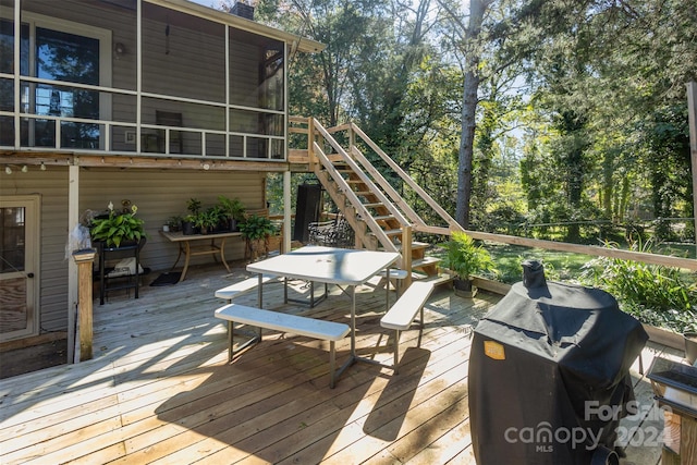 deck featuring a grill and a sunroom