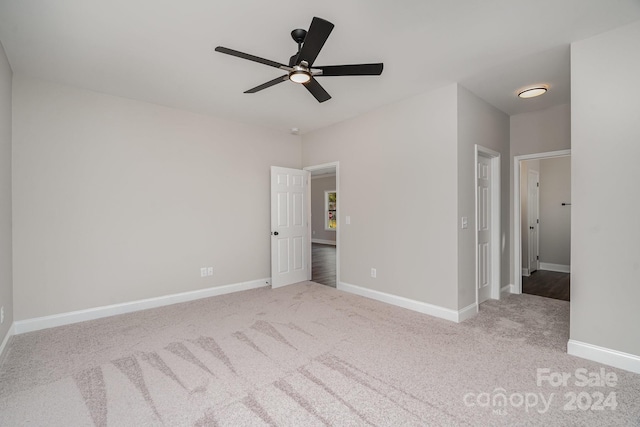 unfurnished bedroom featuring ceiling fan and light colored carpet